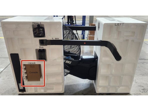 Insert the console box into the left side of the clamshell in the spot shown in the picture.  Secure using a piece of packing tape.