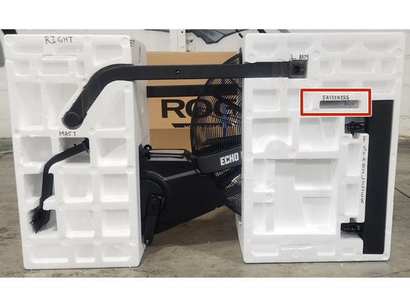 Roll the ziploc bag containing the fasteners up.  Insert the ziploc bag into the right side of the clamshell in the spot shown in the picture.  Secure using a piece of packing tape.