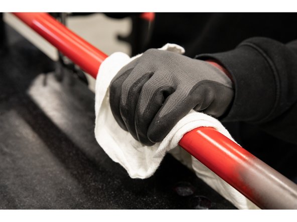 With a clean rag or paper towel, wipe off the excess oil from the bar shaft and the two bushings located inside of the bar sleeve.