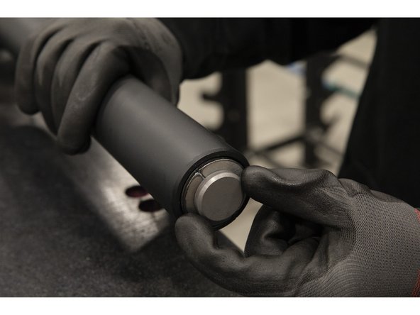 Insert the greased split washers around the groove of the bar shaft.