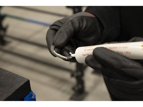 Apply grease and spread it evenly around both sides of a full washer.