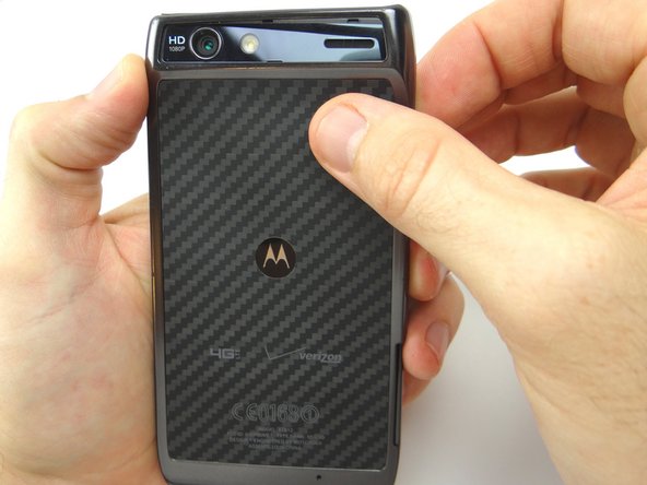 Picture 2: Use your fingers to gently peel the battery cover from the phone.