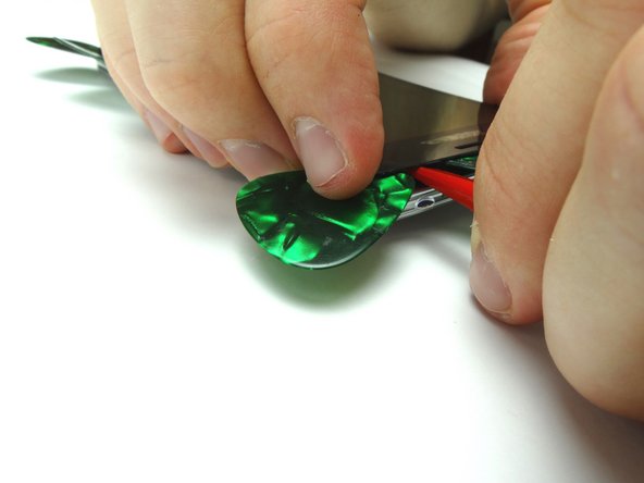 Wedge the spudger between the screen and mid-frame.  Twist to pry up the screen enough to grab the top edge with your fingers.