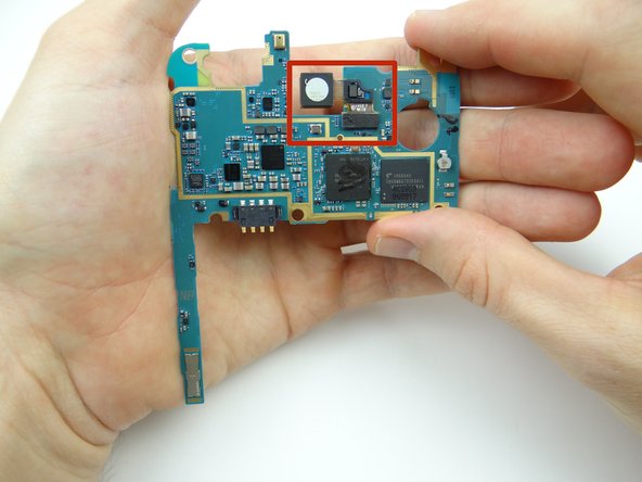 Use a blue pry tool to disconnect the rear camera on the underside of the logic board.