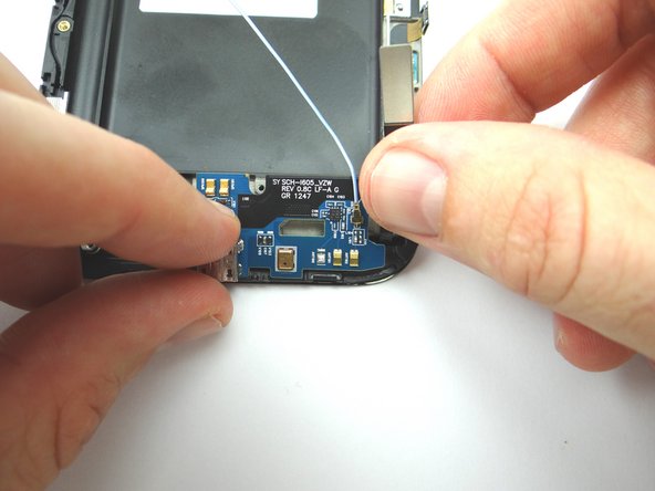 Use your fingers to gently lift the charging port board from the phone. Place into COMPARTMENT G.