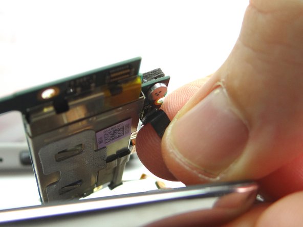 Pictures 2 &amp; 3: Lift the logic board up about an inch.  Pinch the front-facing camera cable.  Gently pull it free from the logic board.  Place it in COMPARTMENT D.