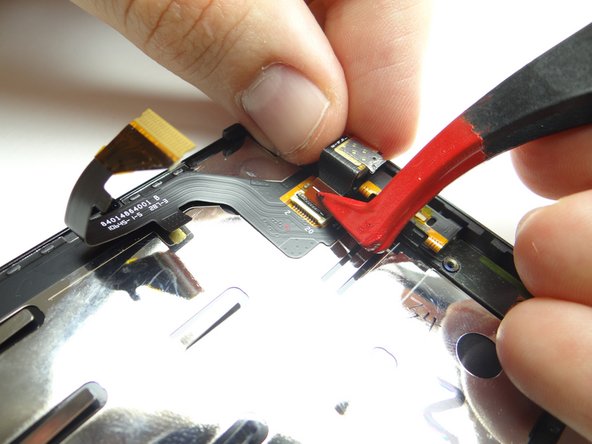 Picture 2: Hold the camera in place while pushing the cable into the connector with plastic tweezers.