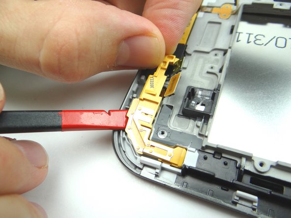 Picture 2: Lift corner bracket with spudger and fingers.  Place in ZONE I.