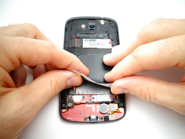 Peel up the tape covering the logic board.