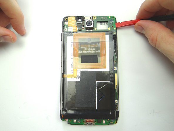 Picture 1: Insert the flat end of the spudger in the upper-right corner between the logic board and display assembly.  Lift up and grab the top of the logic board with your fingers.