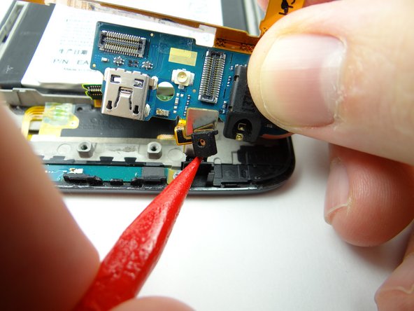 Picture 2: It may get stuck when you reach the microphone socket.  Use the pointed tip of the spudger to lift the microphone.