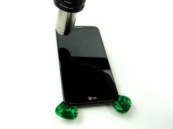 Picture 3: Heat the left side of the display, insert a third guitar pick and roll it up the left side until you reach the upper-left corner.