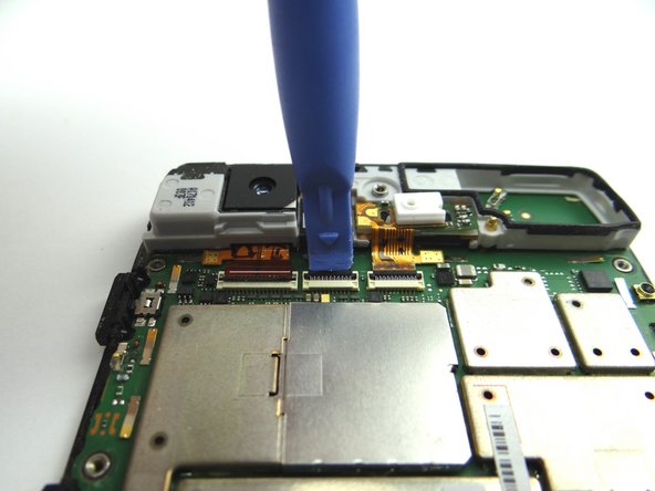 Picture 1: Place blue pry tool under black swing bar of ZIF connector and lift up to open it.