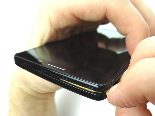 Continue peeling off the corner and nearby edges of the battery cover.