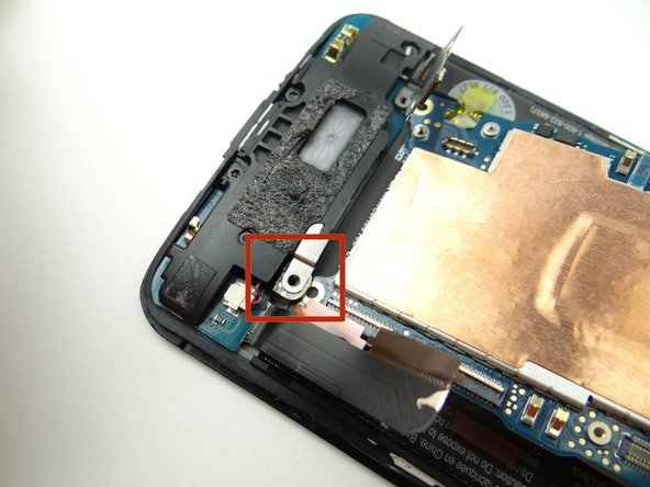 Make sure the opening on the logic board sits under the tab on the charging port (red square).