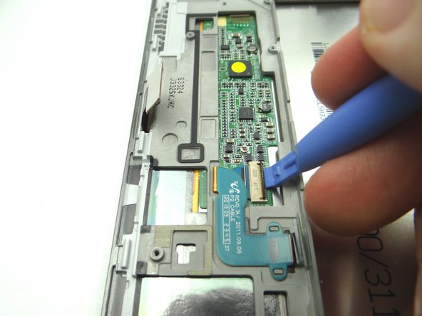 Open LCD ZIF connector with blue pry tool.
