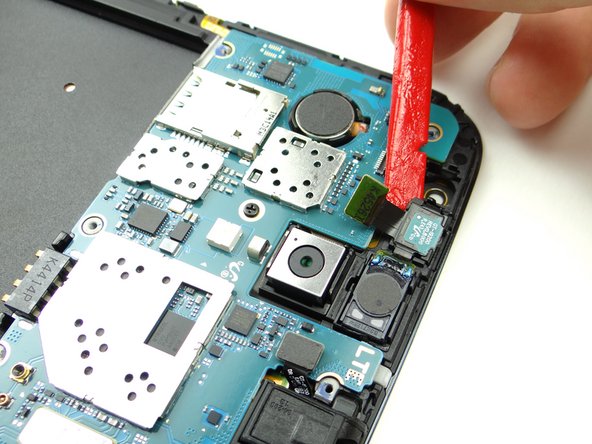Wedge the flat end of the spudger under the infrared sensor and pry up slightly.