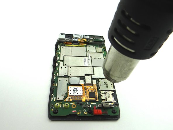 Pictures 2 &amp; 3: Apply low-level heat (100° Celsius) to the perimeter of the logic board to loosen the adhesive.