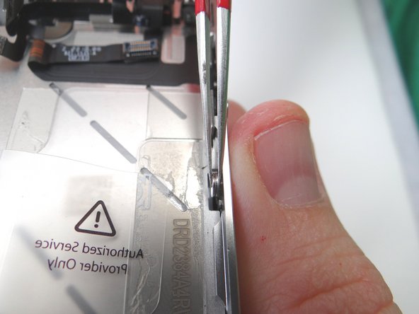 Picture 2: If adjustments are needed, use the Fine Point Tweezers to hold the washer and screw in place while situating the display mounting tabs.