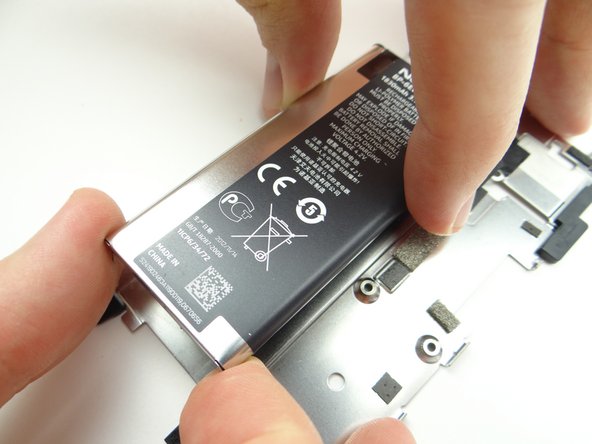 Continue removing the battery with your fingers.