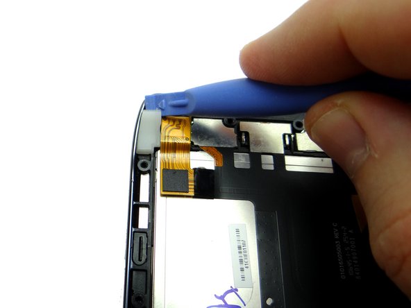 Lift the edge of the rubber gasket in the upper-left corner of the display assembly.