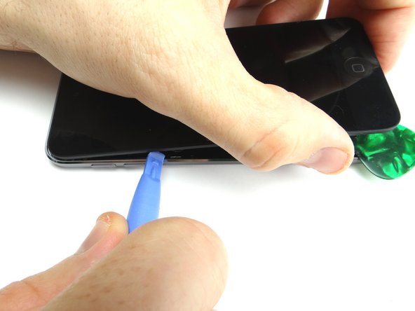 After releasing the clips holding the front panel in place, use your fingers to open the iPod.