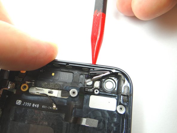 Picture 1: Use the tip of the Black Spudger to push through the power button and ribbon cable. Place power button in COMPARTMENT F.