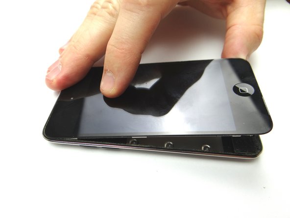 Picture 2: Gently pry the bottom of the screen free from the rear case with your fingers.