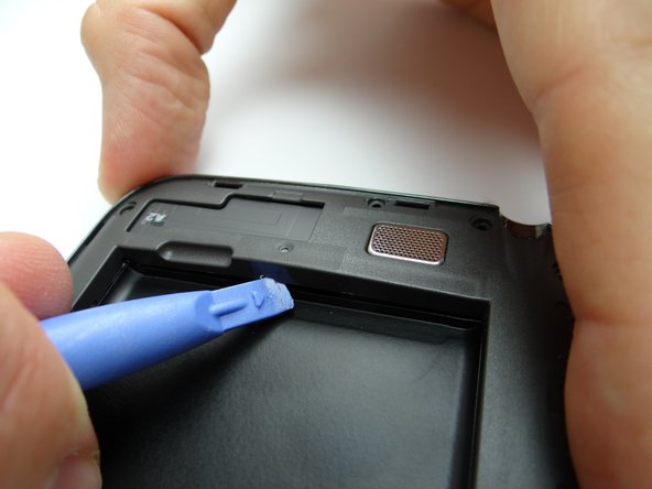 Pictures 1 &amp; 2: Use the Blue Pry Tool to free the clips on the bottom and top of the battery holding area.