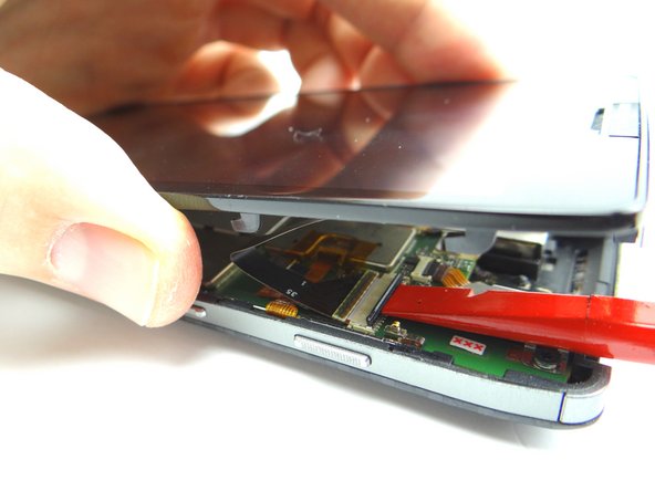 Picture 1: Use flat end of spudger to push the black ZIF connector bar into open position as shown.