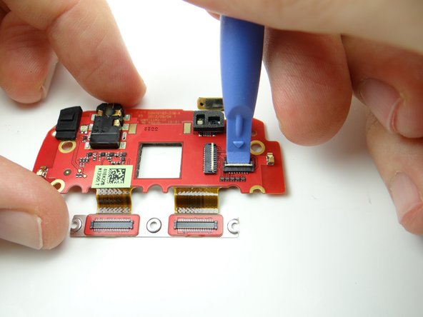 Use the blue pry tool to open the front-facing camera ZIF connector.