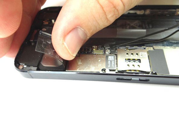 Picture 2 &amp; 3: The charging port assembly cable is adhered to the logic board – gently peel it free from the logic board, working top to bottom until cable is free of logic board. Be cautious as this cable is very fragile.