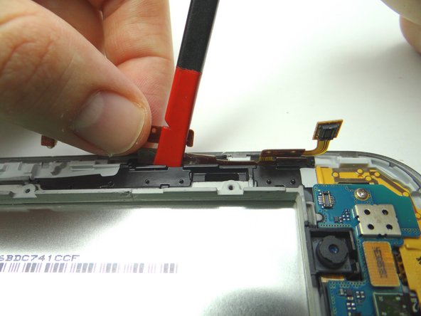 Pictures 1 &amp; 2: Separate the cable from the mid-plate with the spudger while peeling it away with your fingers.