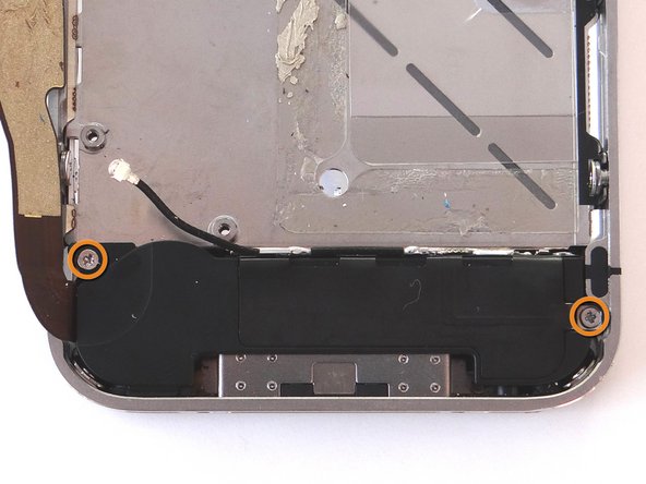 Remove the two 2.4 mm Phillips screws from the sides of the speaker enclosure assembly.  Place in SLOT 12.