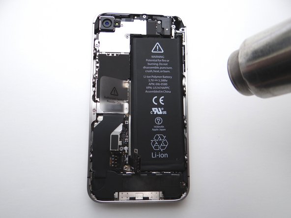 Apply low-level heat (100* Celcius or less) to edges of battery for 60 seconds to loosen the adhesive securing the battery to the iPhone.