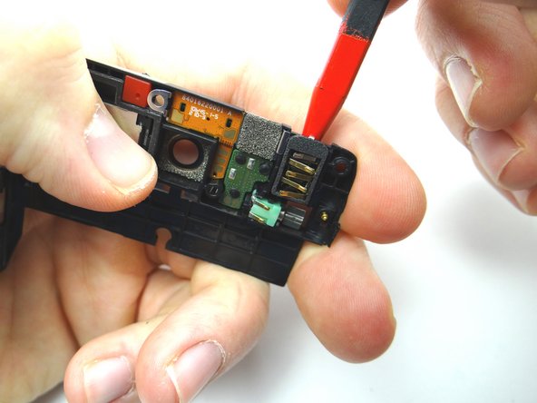 Picture 1: Use the pointed end of the spudger to wiggle the headphone jack.