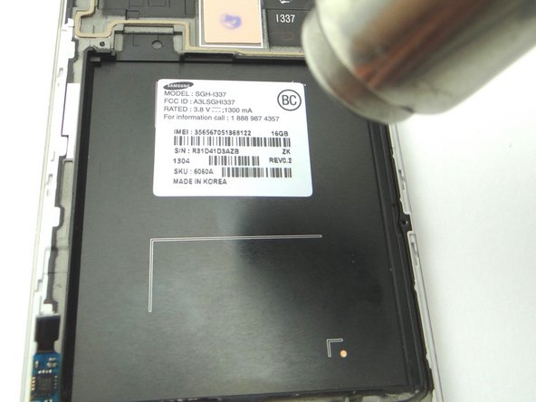 Apply heat to the IMEI sticker for approximately 20 seconds to loosen the adhesive.