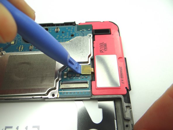 Picture 3: Use blue pry tool to disconnect opposite loudspeaker from logic board.