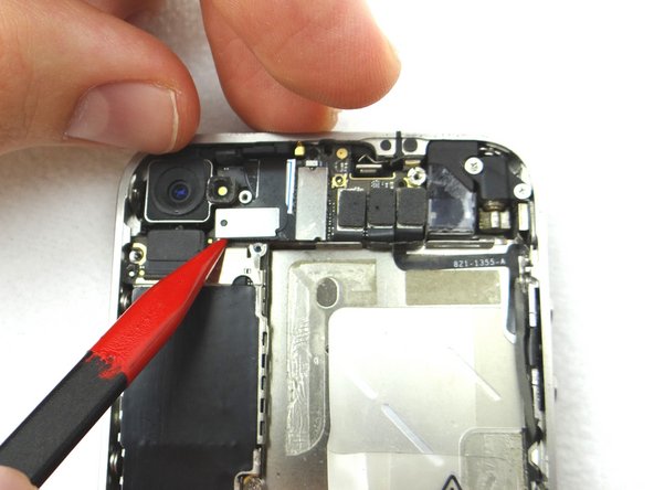 Picture 2: Use the flat end of the black spudger to gently pry three cables free from their sockets on the logic board.