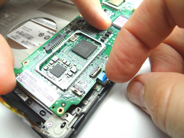 Pictures 1 &amp; 2: Seat power button cable then gently push the logic board into place. Make sure the logic board is situated under the clip marked in Picture 2.