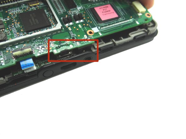 Picture 2: Carefully guide the charging port and headset jack (soldered to the bottom of the logic board) free.
