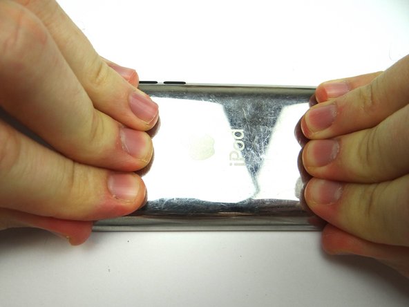 Turn the iPod over and press the screen firmly into place, putting moderate pressure at the top and bottom as pictured.  Hold for two minutes.