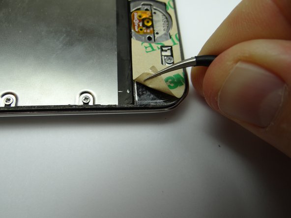 Picture 2: Repeat with adhesive strip at the bottom, but don't close the iPod