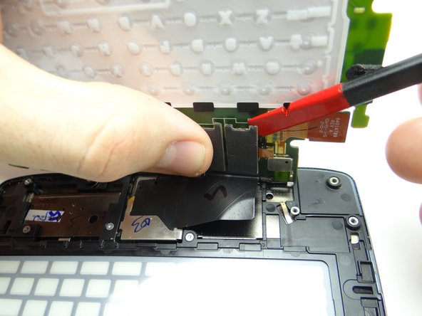 Use the flat end of the spudger to disconnect the two display cable connectors.