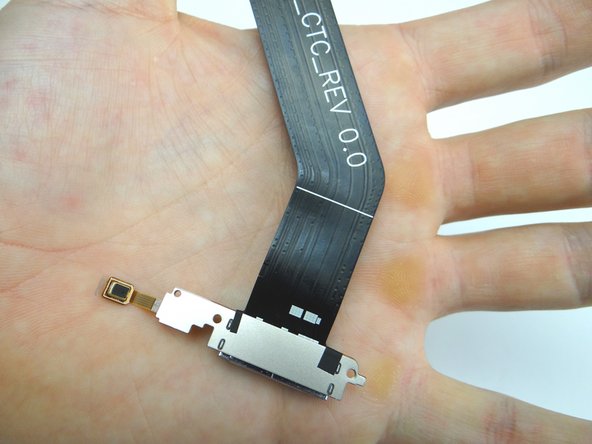 Pictures 2:  Pull up the right side of the charging port until the microphone starts to stick.  Pinch the microphone with your fingers and peel it up.