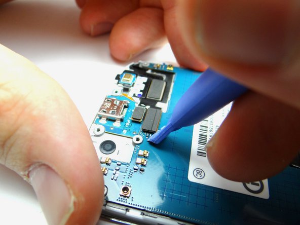 Picture 2: Use the blue pry tool to disconnect charging port cable.