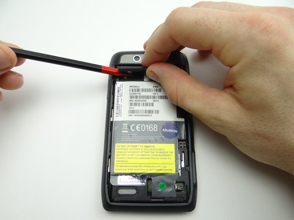 Picture 1: Use a spudger to lift the left edge of the flap covering the SIM and SD cards.