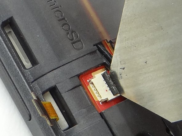 Picture 1: Cautiously open the volume rocker cable ZIF connector with an iSesamo tool.