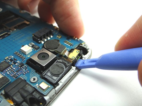 Picture 2: Use blue pry tool to lift proximity sensor up enough to grab with your fingers.