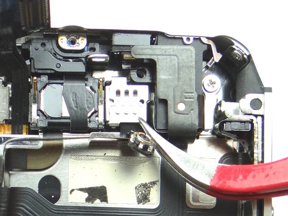 Use the Curved Tip Tweezers to place the metal plate over the front-facing camera: